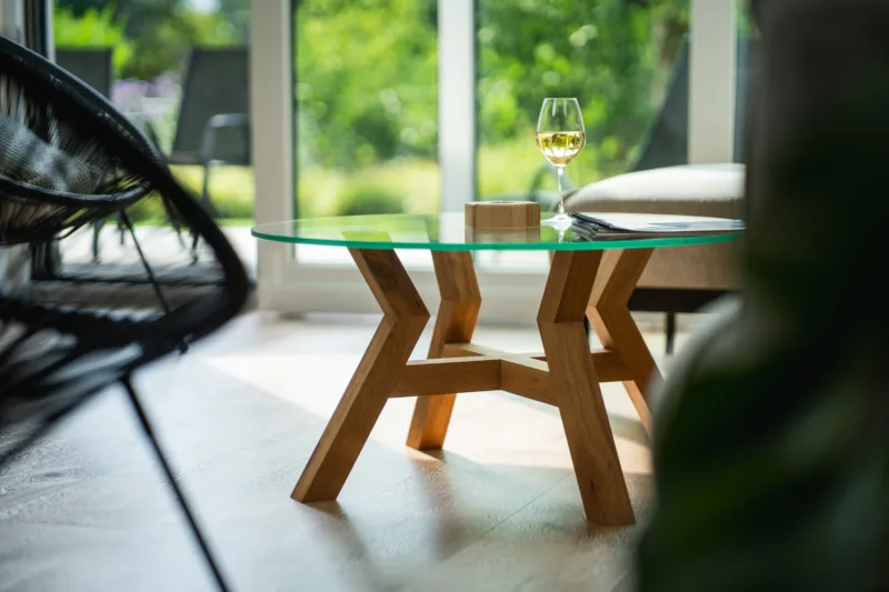 Konferenční dubový stůl Bon Veyron se skleněnou deskou Glase Cir 80 cm v interiéru pohled zboku zblízka.